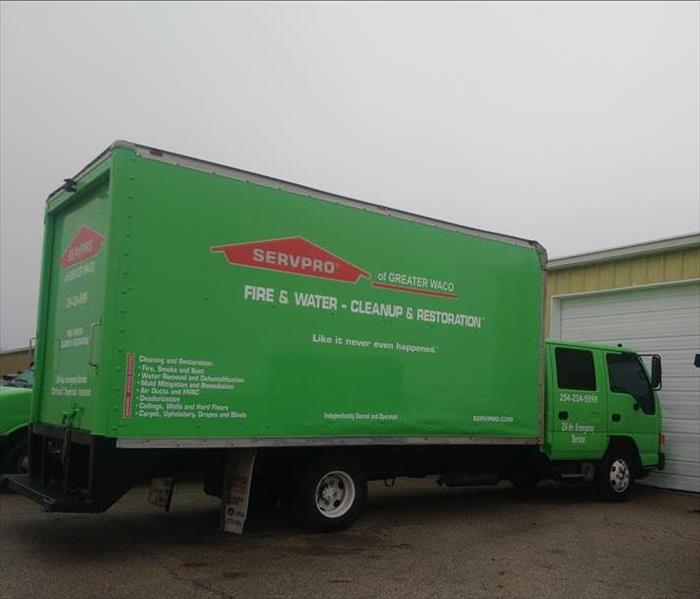Parked bright green truck with SERVPRO of Greater Waco logo and phone number decals outdoors