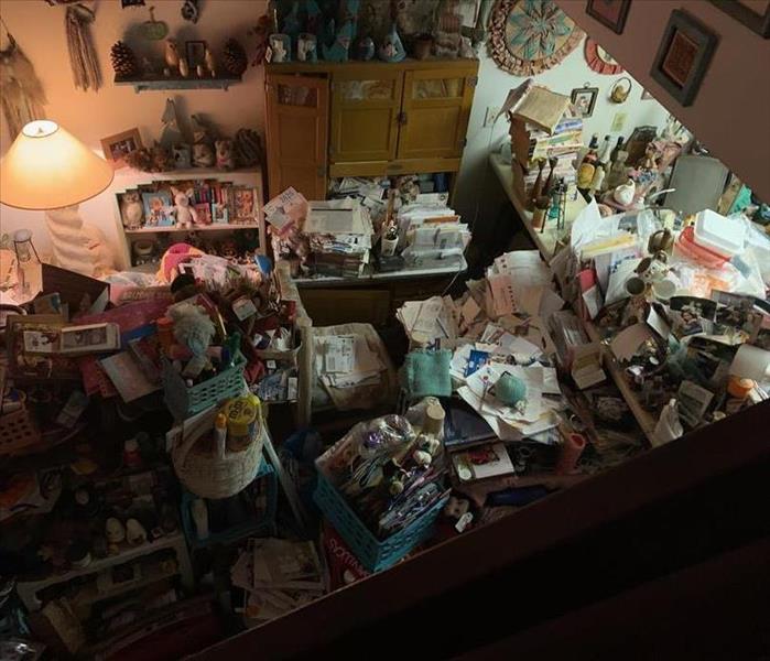 A cluttered bedroom belonging to an individual with hoarding disorder